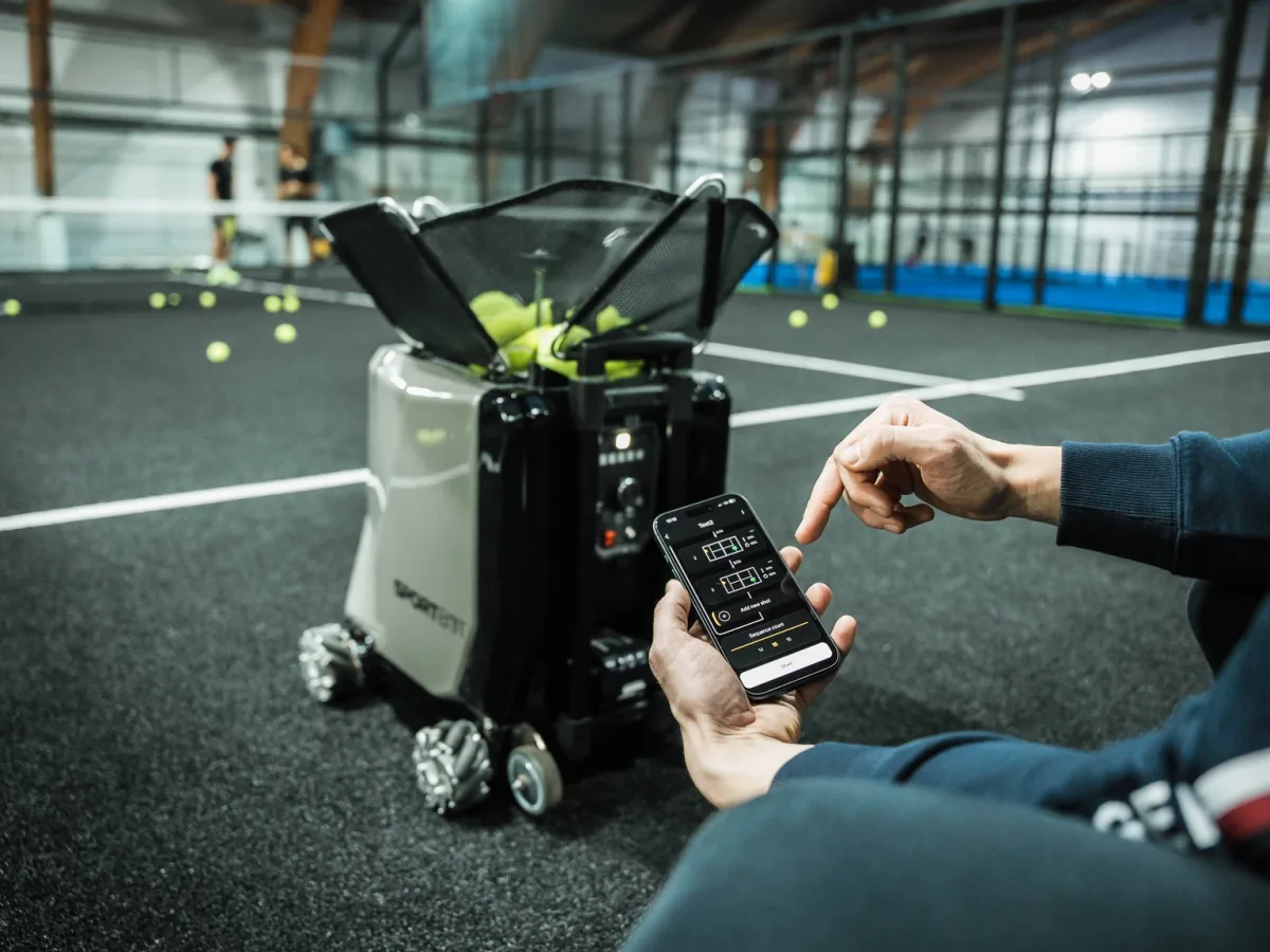 Coach setting a Sportbot drill on a padel court