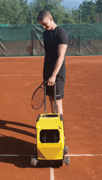 Tennis player with a tennis ball machine