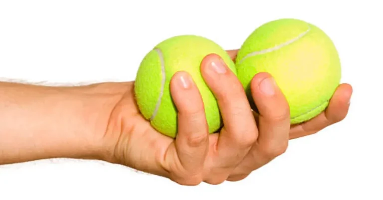 Two tennis balls in hand