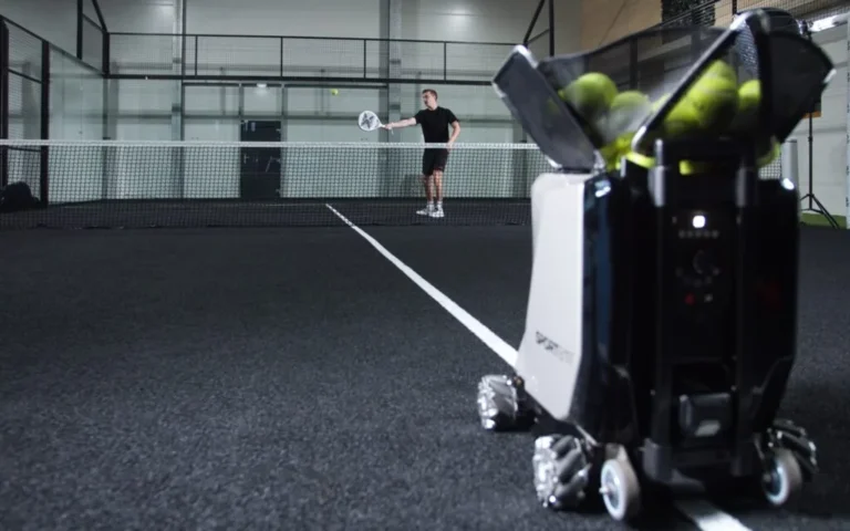 Padel player training with Sportbot on an indoor padel court